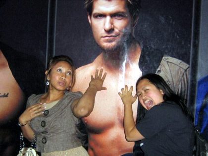 Being silly in front of the Chippendales ad
